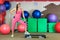 Young beautiful white girl in a pink sports suit with dumbbells stands near the step before training in a fitness club.