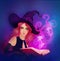 Young beautiful witch holding a magic bok