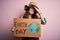 Young beautiful woman asking for planet conservation holding cardboard celebrating earth day stressed with hand on head, shocked