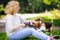 Young beautiful woman with Beagle dog in the summer park