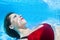 Young beautiful woman in bikini diving underwater in swimming pool