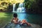 Young beautiful woman in bikini explore waterfall hidden in the tropical jungle on background amazing wild tropical nature