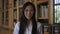 Young beautiful woman biologist is posing in good mood standing in library.