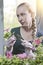 Young beautiful woman with a braid seedling petunia in boxes in the spring