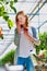 Young beautiful woman buyer smelling tomatoes in greenhouse