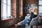 Young beautiful woman in a chair in a modern home / loft.