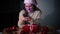 Young beautiful woman in Christmas hat looking to the smartphone screen