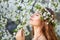Young beautiful woman in circlet of flowers