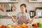 Young beautiful woman is cooking in the kitchen.