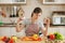 Young beautiful woman is cooking in the kitchen.