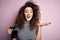 Young beautiful woman with curly hair and piercing doing coffee holding french coffeemaker very happy and excited, winner