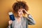 Young beautiful woman with curly hair and piercing holding Germany passport id and dollars stressed with hand on head, shocked