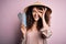 Young beautiful woman with curly hair and piercing wearing asian hat holding boarding pass with happy face smiling doing ok sign