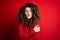 Young beautiful woman with curly hair and piercing wearing casual red sweater shaking and freezing for winter cold with sad and