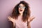 Young beautiful woman with curly hair and piercing wearing funny thug life sunglasses celebrating mad and crazy for success with