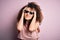 Young beautiful woman with curly hair and piercing wearing funny thug life sunglasses suffering from headache desperate and
