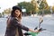 Young and beautiful woman with dark and curly hair is sightseeing in seville while driving an electric motorbike to move around