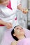 Young beautiful woman with dark hair gets procedure in the beauty salon