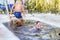 young beautiful woman dives into an ice hole on a winter day