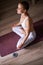 Young and beautiful woman do yoga exercises at home in livingroom