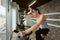 Young beautiful woman doing indoor biking exercise