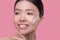 Young beautiful woman doing usual skincare procedure