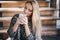 Young beautiful woman drinking cocoa in a wooden coutry house