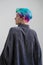 Young beautiful woman with dyed blue and green hair. Pixie bob short haircut The concept of hair styling.