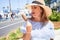 Young beautiful woman eating ice cream cone walking down the street of Tenerife on a sunny day of summer on holidays