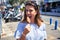 Young beautiful woman eating ice cream cone walking down the street of Tenerife on a sunny day of summer on holidays