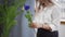 A young beautiful woman engaged in floristry begins to collect the best flowers for her flower arrangement. Floristry