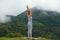 Young beautiful woman is engaged in hatha yoga in the morning misty mountains