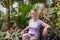 Young beautiful woman enjoy beautiful flowers in tropical garden