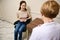 Young beautiful woman explains her health complaints to the attending physician during a visit in medical clinic