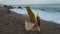 Young beautiful woman fallen angel stands on sea beach enjoy nature. costume bird white wings.