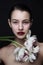 Young beautiful woman with fancy makeup and white tulips