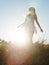 Young beautiful woman in a field being carefree.