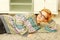 Young beautiful woman in glasses lying on the carpet