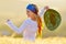 Young beautiful woman on golden cereal field