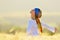 Young beautiful woman on golden cereal field