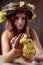 Young beautiful woman with grapes. Vine wreath with grapes on a head. Beautiful girl with long wavy hair and perfect make-up.