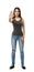 Young beautiful woman in gray sleeveless top and blue jeans standing and holding right hand out in stop gesture isolated