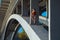 Young beautiful woman gymnast posing on bridge girder