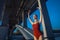 Young beautiful woman gymnast posing on bridge girder