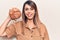 Young beautiful woman holding bread looking positive and happy standing and smiling with a confident smile showing teeth