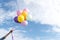 Young beautiful woman holding colorful air balloons in the park.  Relaxation on international womans day