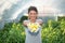 Young beautiful woman holding fresh delicious yellow pepper with hands and smile after she picked up it in greenhouse new small bu