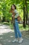 A young beautiful woman holds a dog in her arms for a walk. non-barking african basenji dog.