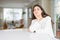 Young beautiful woman at home on white table thinking looking tired and bored with depression problems with crossed arms