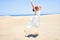 Young beautiful woman jumping crazy at maspalomas dunes beach